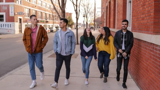Group of young people walking down a suburban street